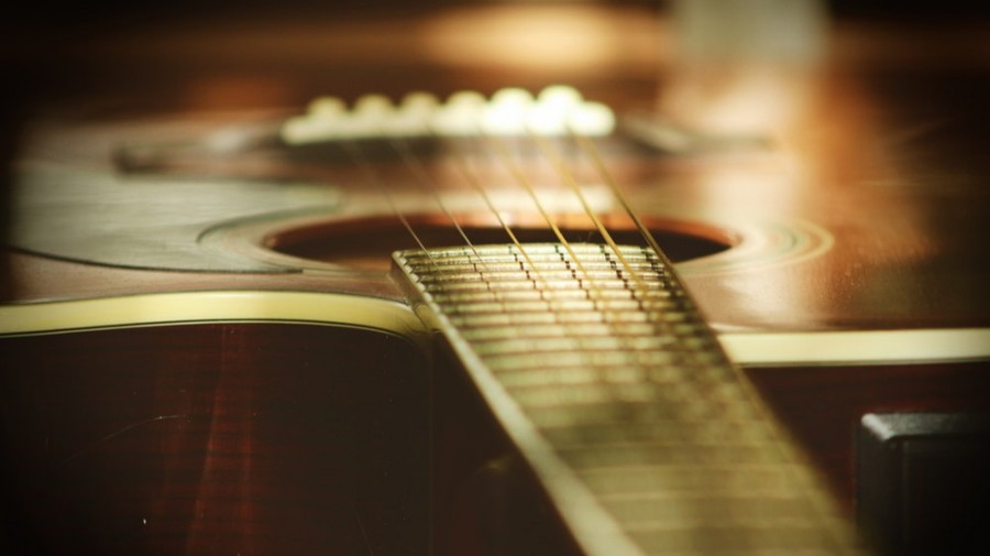 selective focus photography of wooden classical guitar